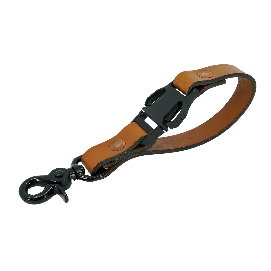Close-up of short fire glove strap made from full-grain leather with matte black hardware – firefighter accessories