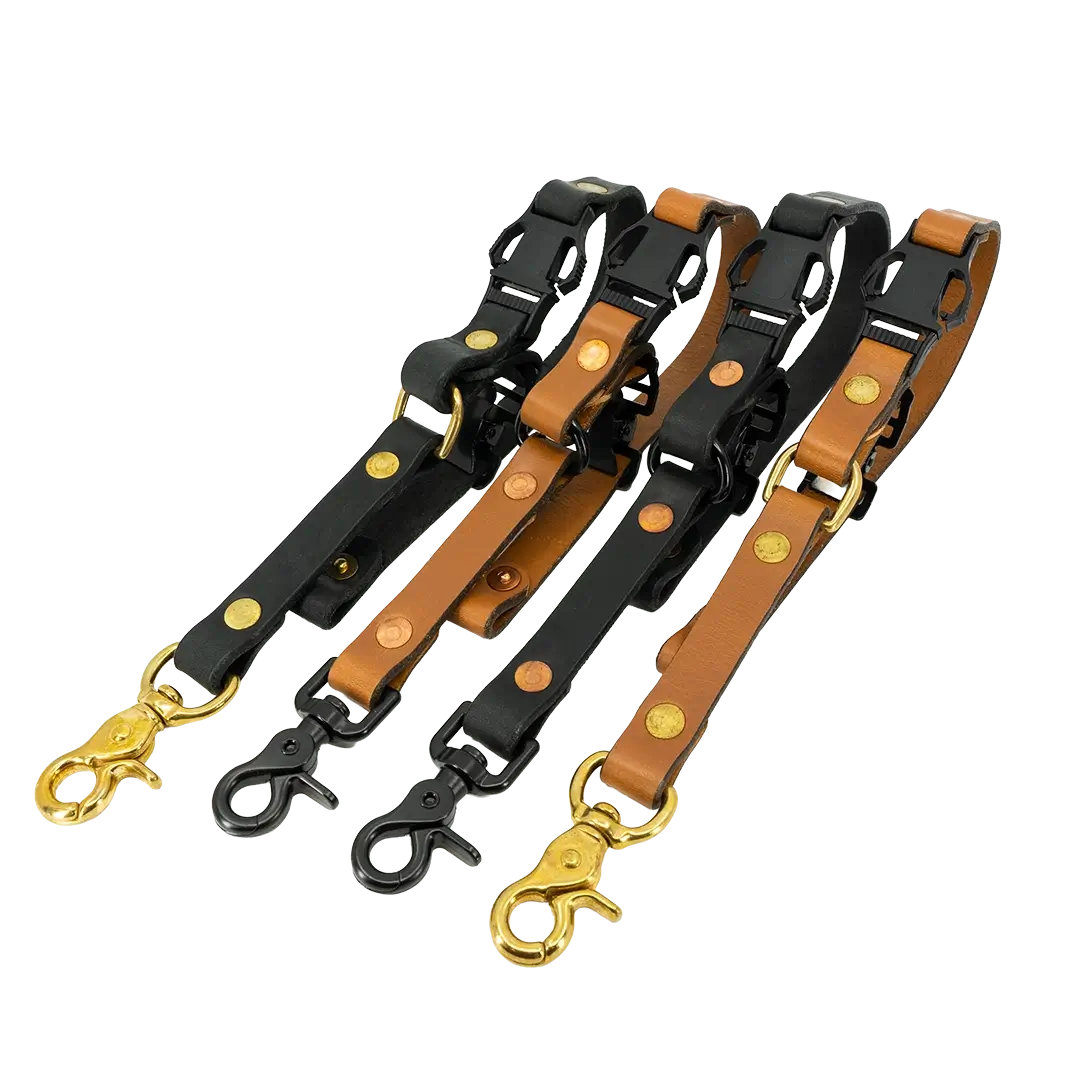 Four leather long adjustable firefighter glove straps in black and tan with hardware variations.