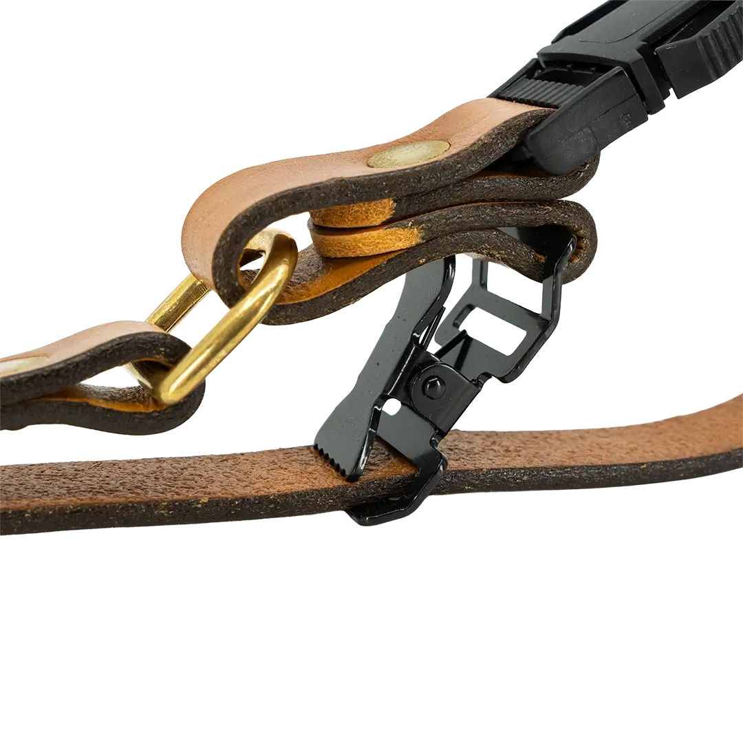 Tan leather fireman glove strap buckle section with black adjustable clip and brass rivets.