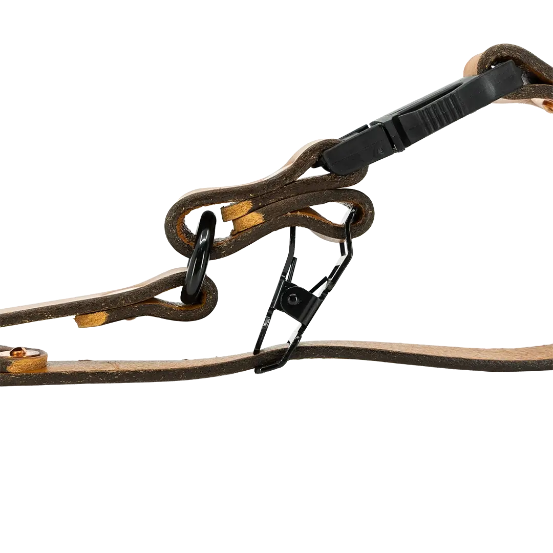 Close-up of black matte snap clip on a tan leather fire glove strap.