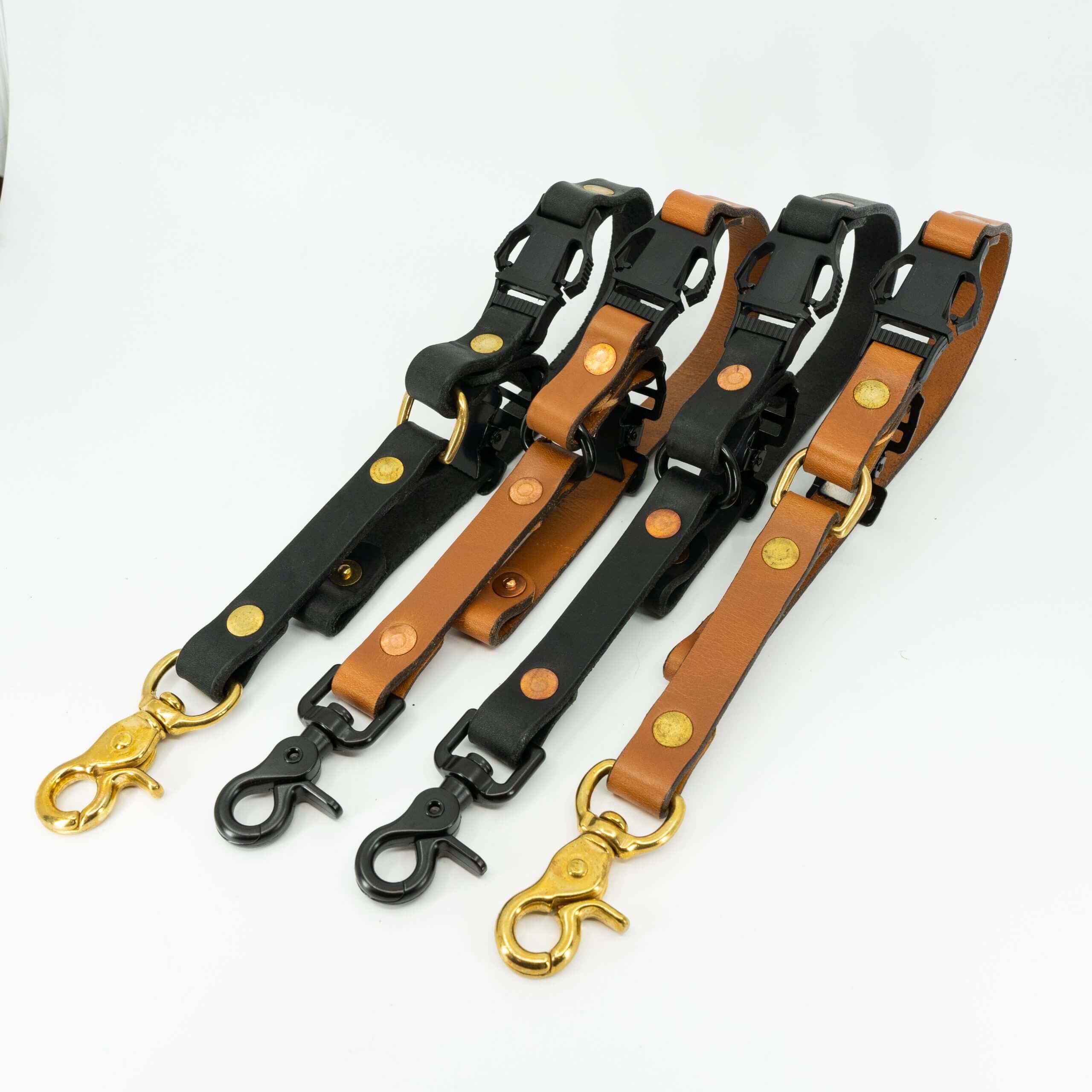 Four leather long adjustable firefighter glove straps in black and tan with hardware variations.