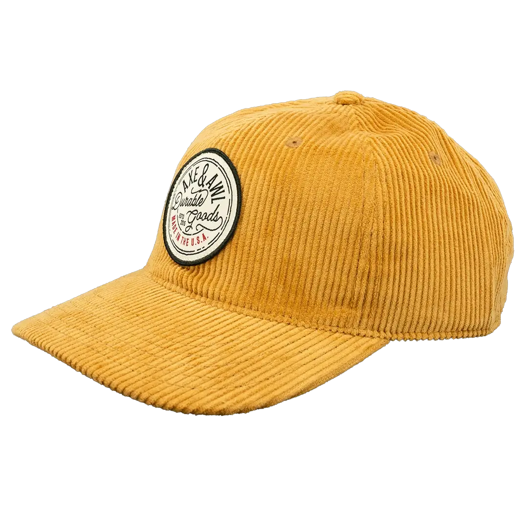 Angle view of gold corduroy hat with durable goods patch