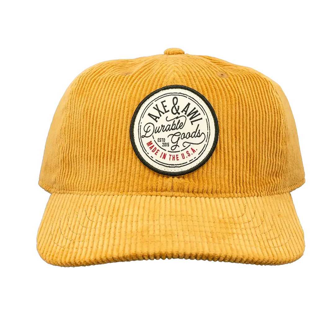 Front view of gold corduroy hat with durable goods patch
