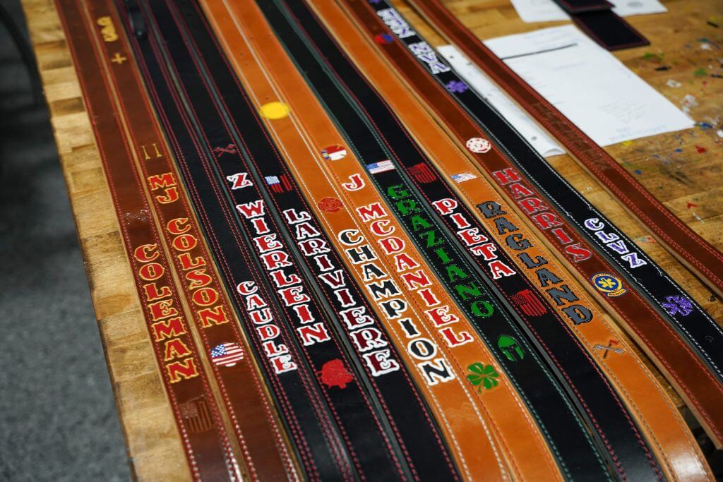 custom radio straps on the paint table at axe and awl leatherworks