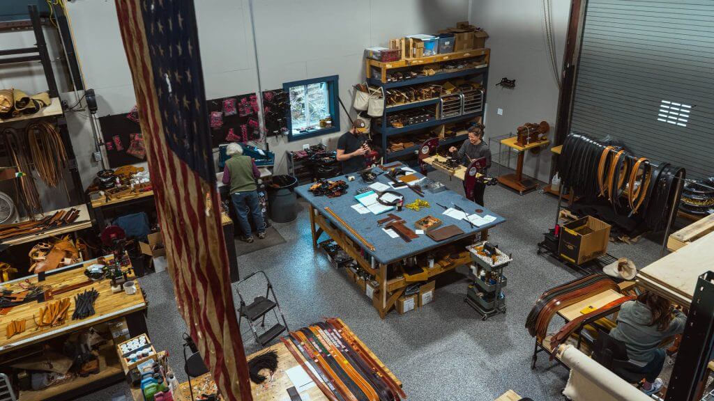 axe and awl leatherworks workshop in waynesville north carolina shot from above of the workshop floor and employees working on leathercrafting