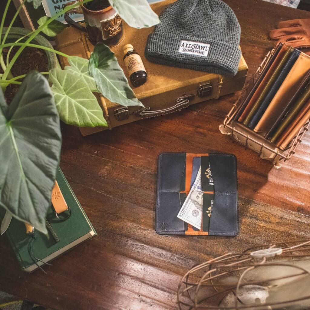 axe and awl leatherworks products seen from above featuring a beanie, and leather wallets. 