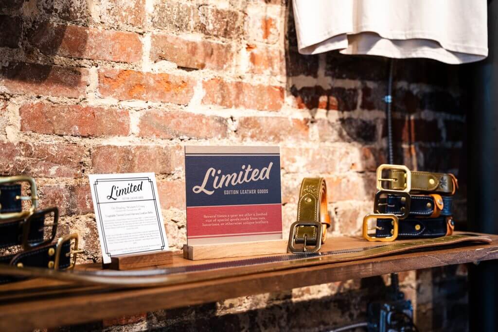 Inside axe and awl leatherworks retail store, limited edition navy and olive leather belts on display