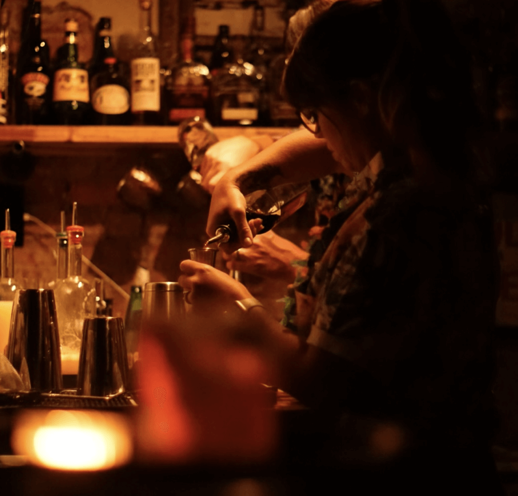Courtney making farm to table craft cocktails inside Bevel Bar