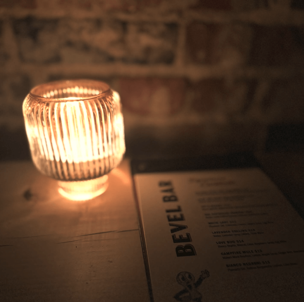 Tea light and Bevel Bar menu inside of Axe and Awl Leatherworks