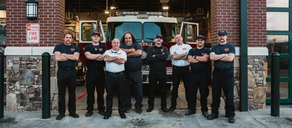 waynesville fire department poses outside their fire station