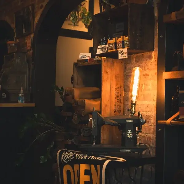 A photo of a lamp that used to be a sewing machine in Axe and Awl